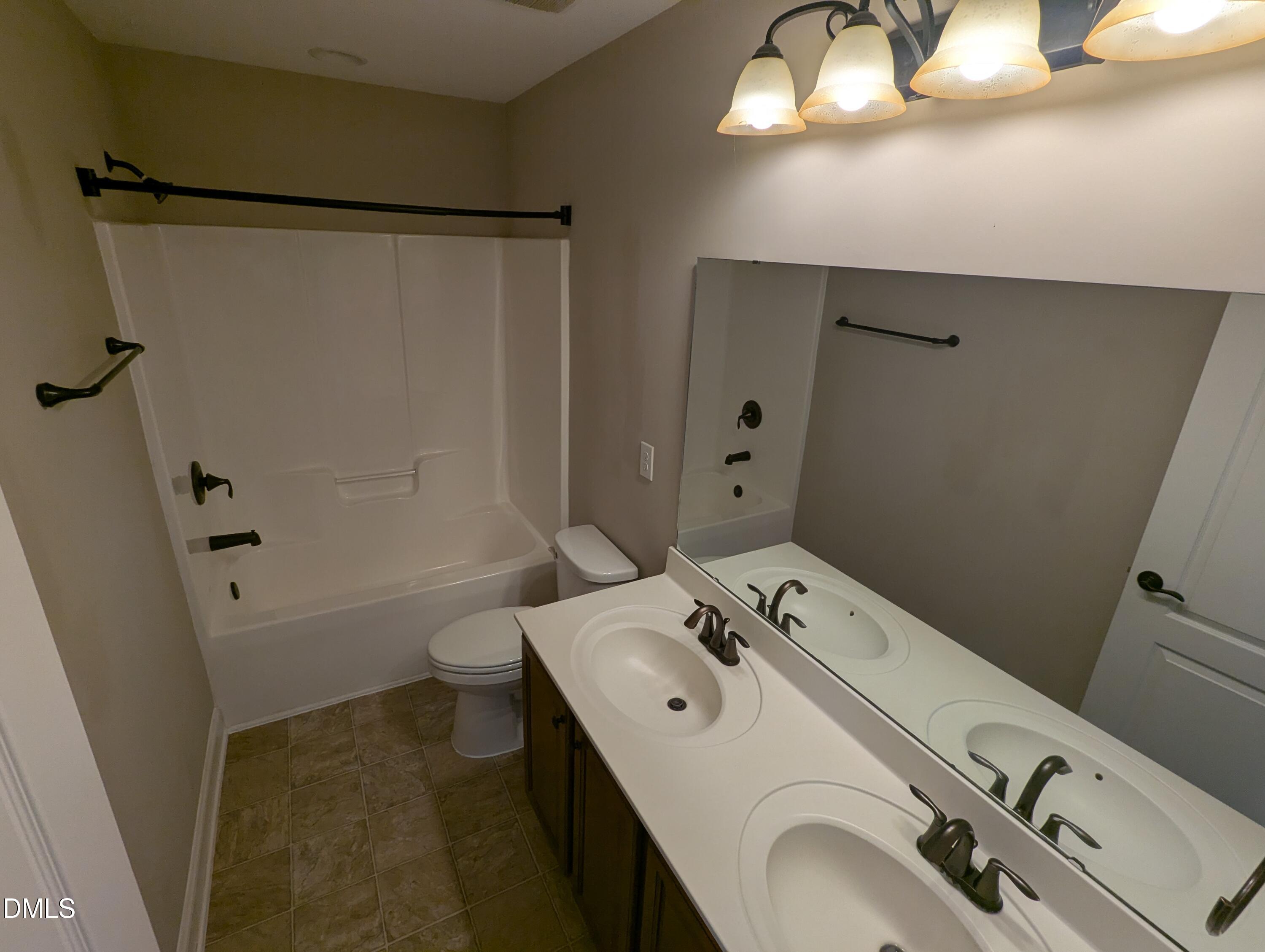 833 Poplar Street Durham, NC 27703 - Photo 19 of 20 a bathroom with a sink and a mirror