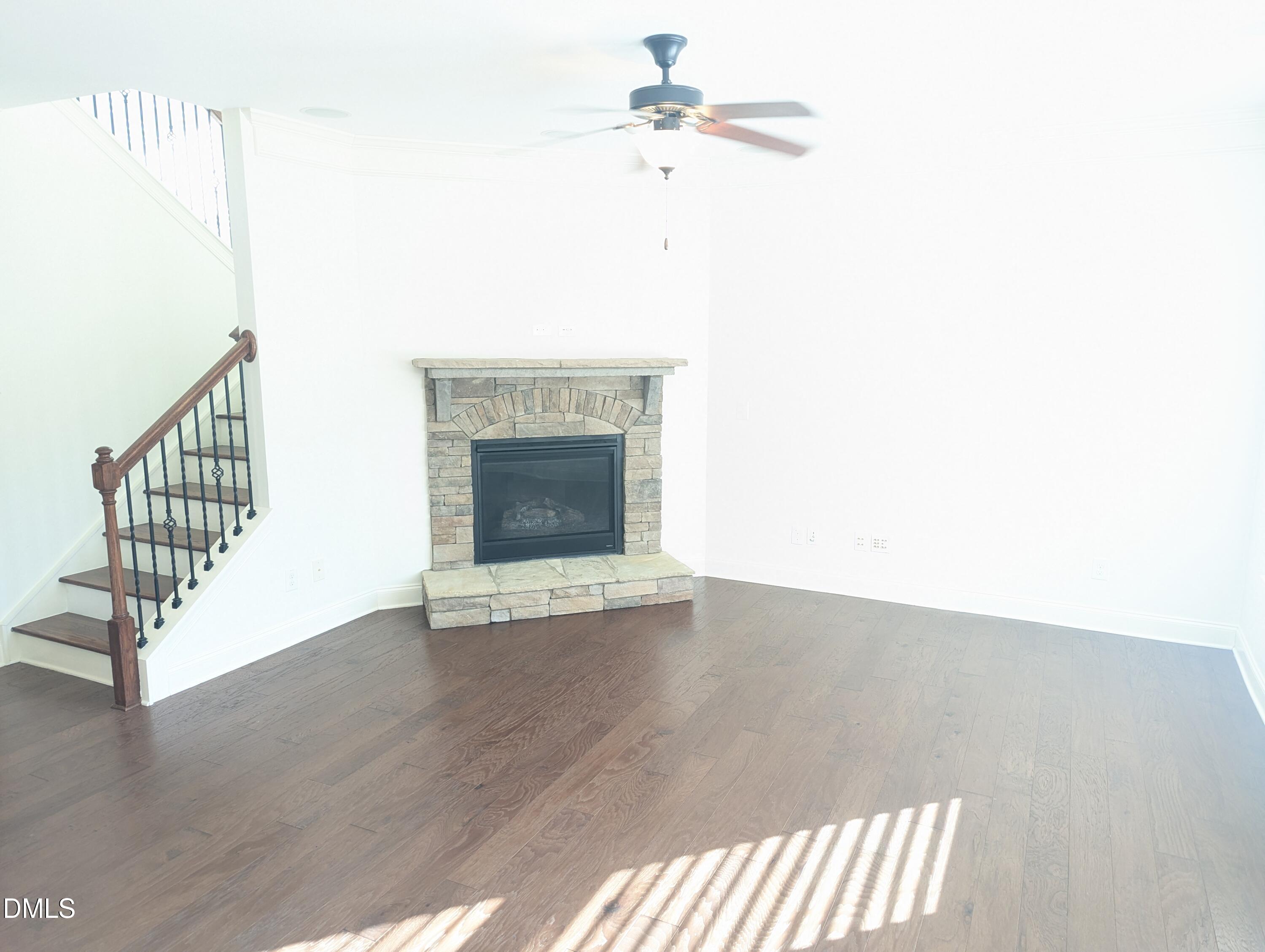 833 Poplar Street Durham, NC 27703 - Photo 2 of 20 a view of an empty room with wooden floor and a fireplace