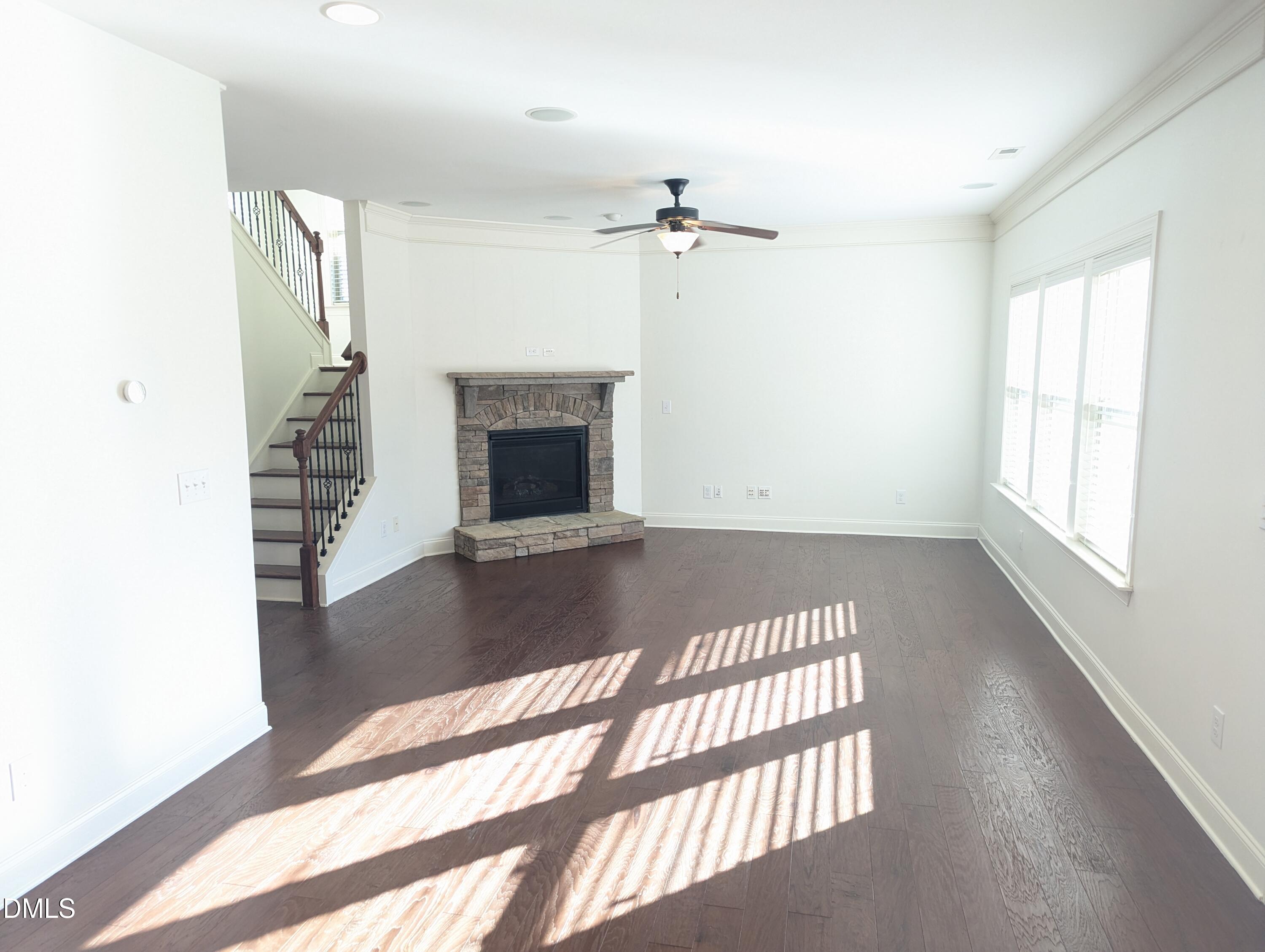 833 Poplar Street Durham, NC 27703 - Photo 3 of 20 a view of an empty room with a fireplace and a window