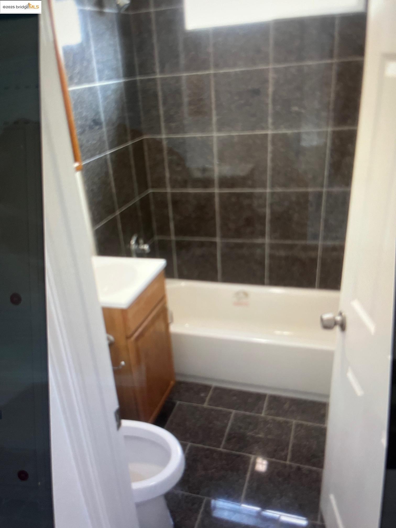 5936 Martin Luther King Jr Way Oakland, CA 94609 - Photo 4 of 5 a bathroom with a bathtub and toilet