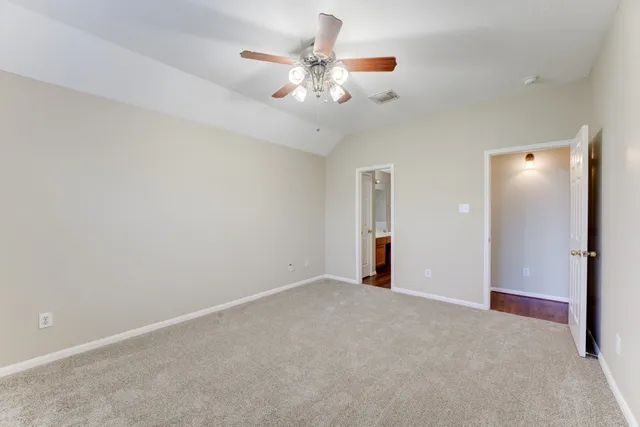 a view of an empty room with a ceiling fan