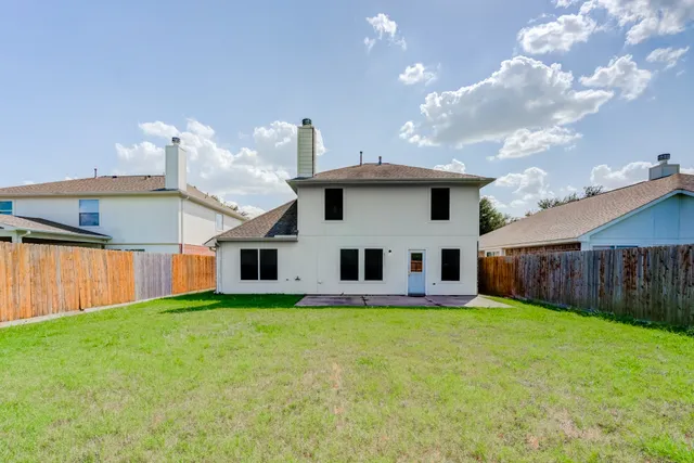 a view of a house with a yard and sitting area