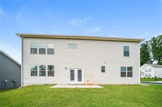 a backyard of a house with table and chairs