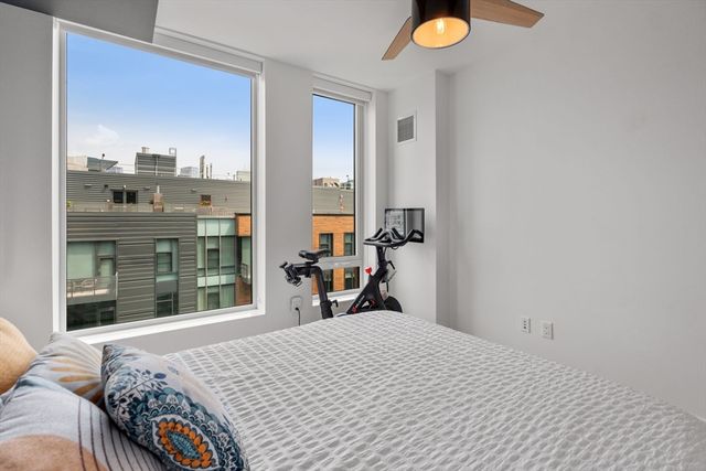 a kitchen with stainless steel appliances granite countertop a refrigerator a sink a stove a dining table and chairs