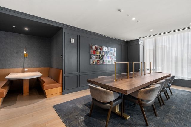 a living room with fireplace furniture and a large window
