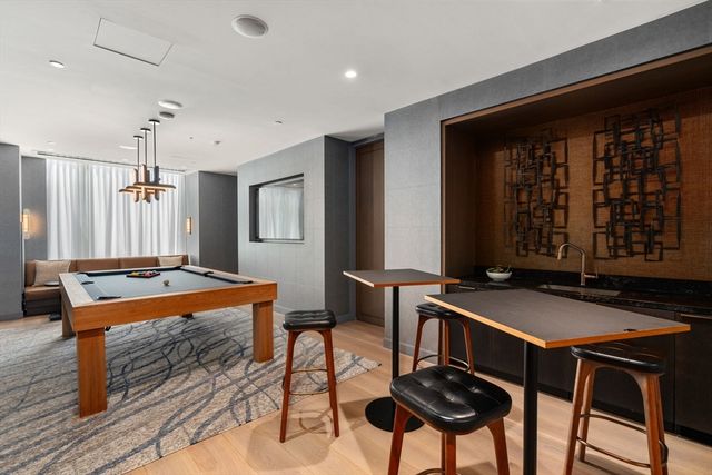 a large white kitchen with lots of counter space and a large window