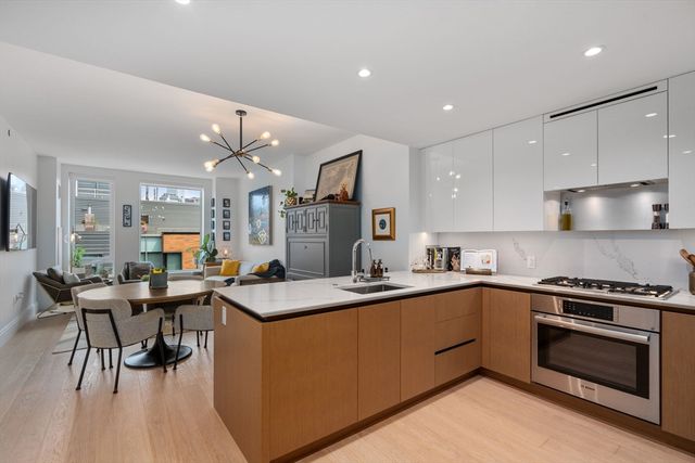a kitchen with a stove a sink and a refrigerator