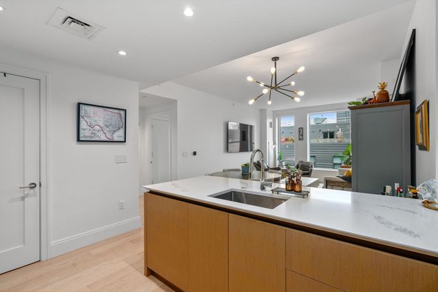 a bathroom with a granite countertop sink a mirror and shower