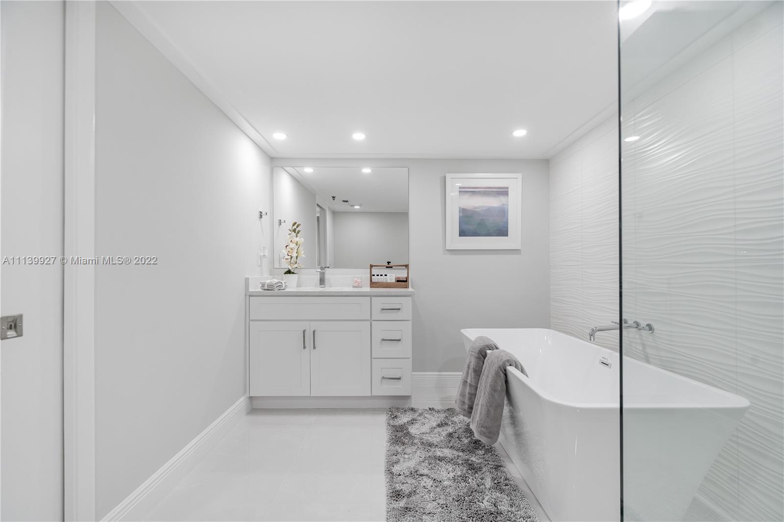 Boca Pointe Boca Raton, FL 33433 - Photo 11 of 41 a bathroom with a bathtub sink mirror and toilet