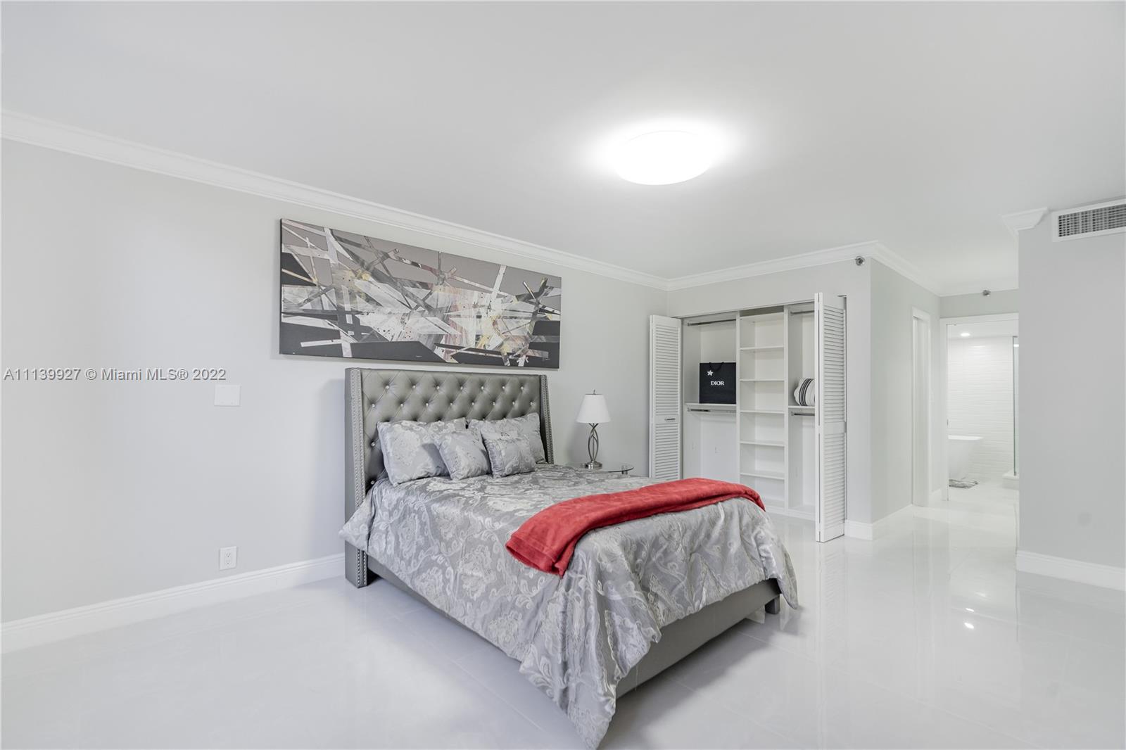 Boca Pointe Boca Raton, FL 33433 - Photo 15 of 41 a bedroom with a bed and a painting on the wall