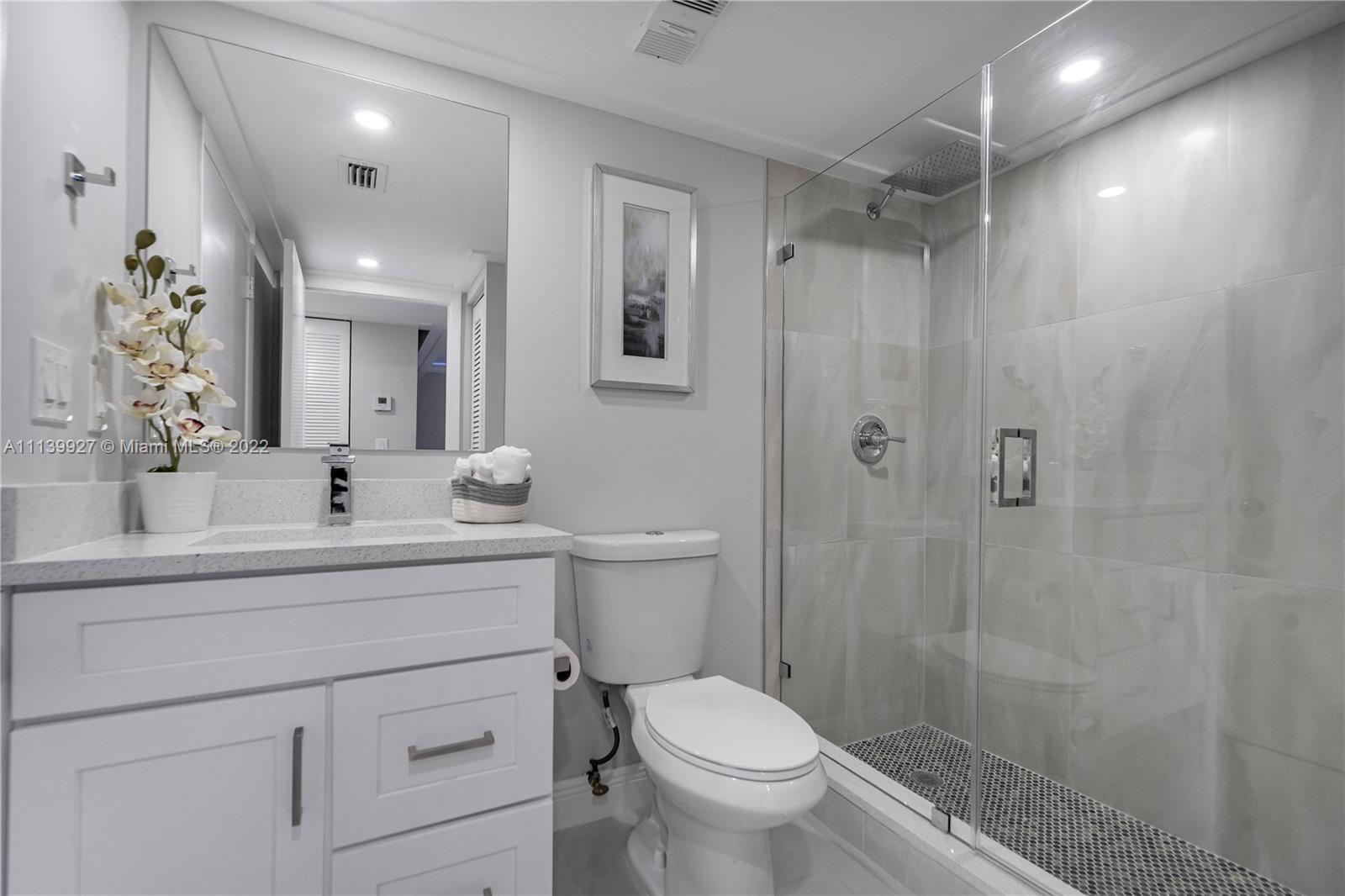 Boca Pointe Boca Raton, FL 33433 - Photo 19 of 41 a bathroom with a sink a toilet and shower