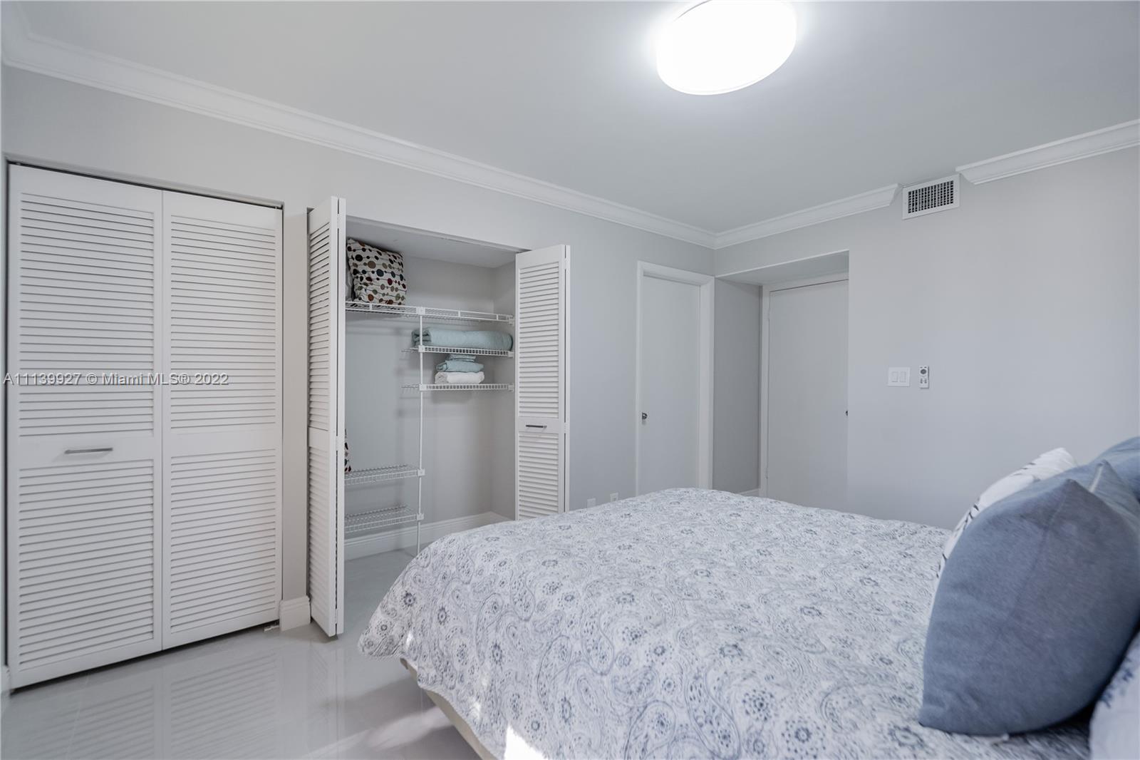 Boca Pointe Boca Raton, FL 33433 - Photo 20 of 41 a bedroom with a bed and a mirror