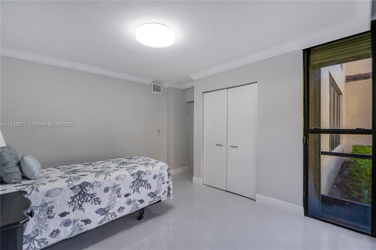 Boca Pointe Boca Raton, FL 33433 - Photo 23 of 41 a bedroom with a bed and a window