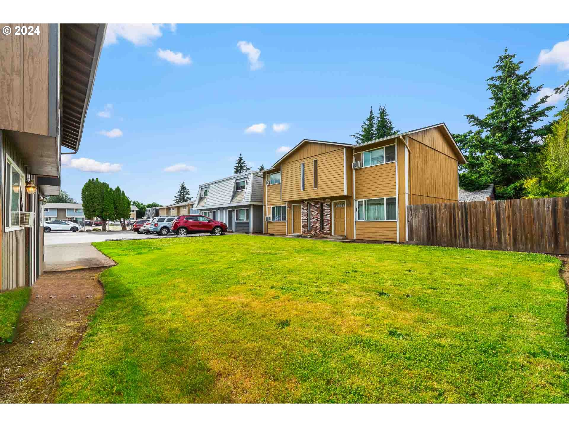 2015 Carlson Road Vancouver, WA 98661 - Photo 9 of 14 a view of a house with a big yard potted plants and large tree
