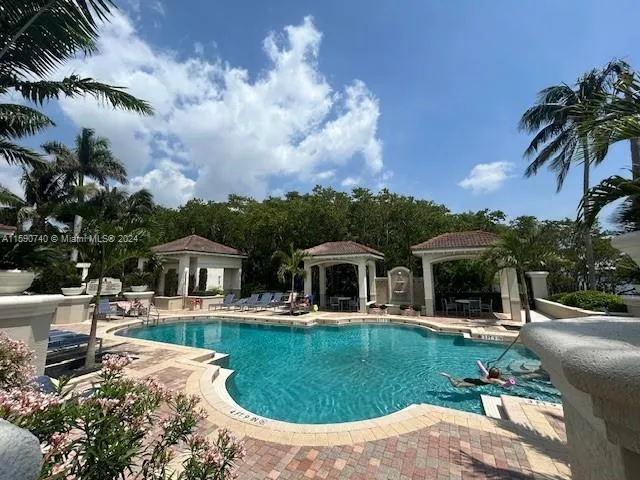 a view of a house with a swimming pool and a yard