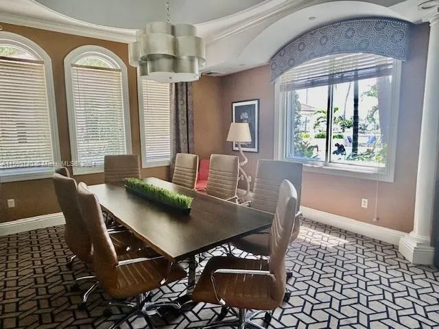 a view of a dining room with furniture wooden floor and chandelier