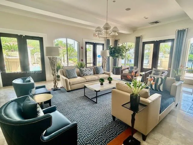 a living room with furniture potted plant and a large window