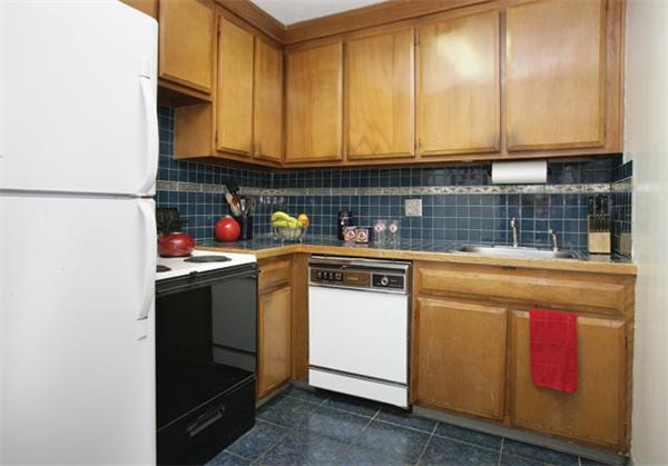 111 Perkins Street, Unit 124 Boston, MA 02130 - Photo 4 of 9 a kitchen with stainless steel appliances granite countertop a sink stove and cabinets