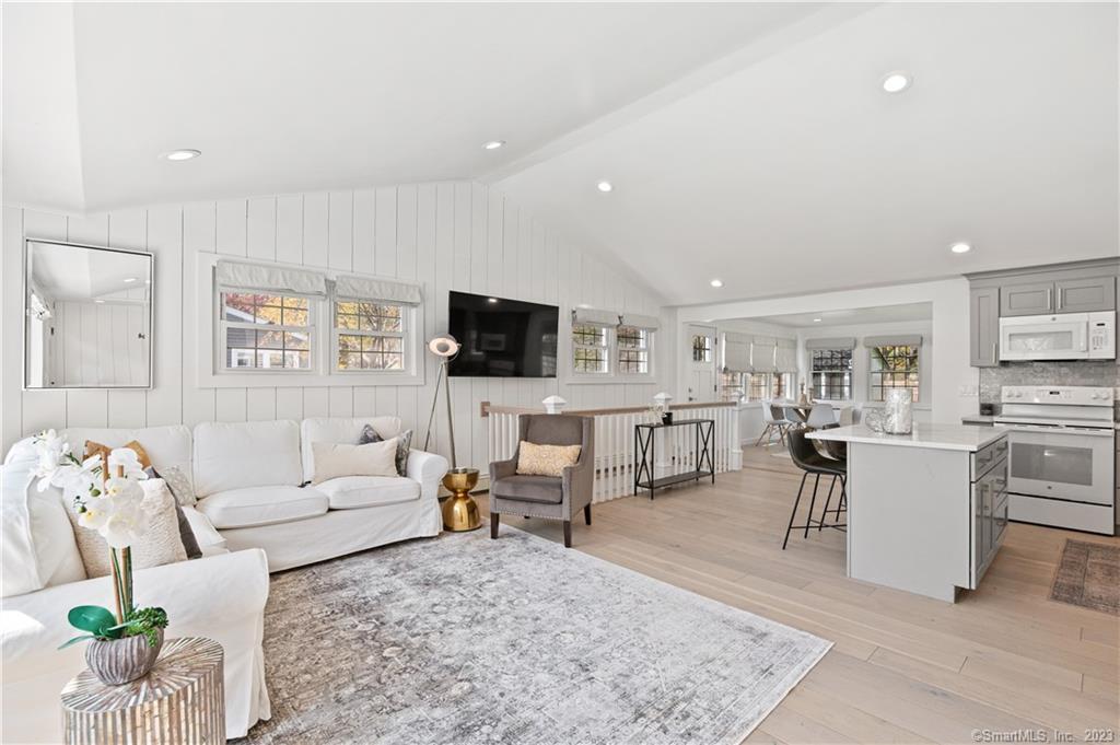 A raised ceiling and vertical shiplap creates a lofted, inviting space