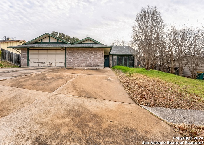 a front view of a house with a garden and yard