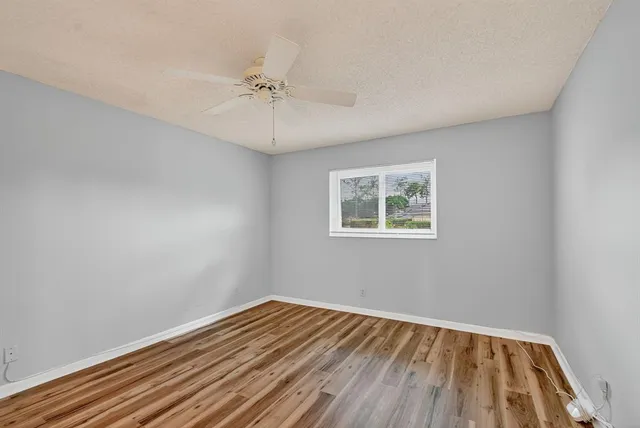 an aerial view of residential houses with outdoor space and street view