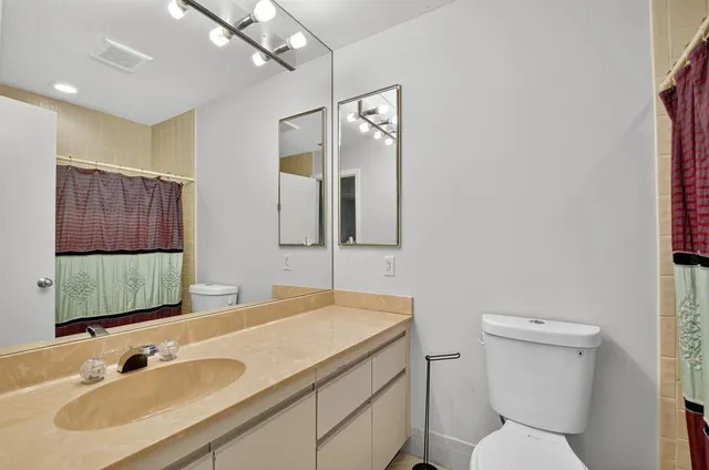 an aerial view of a house with outdoor space and trees all around