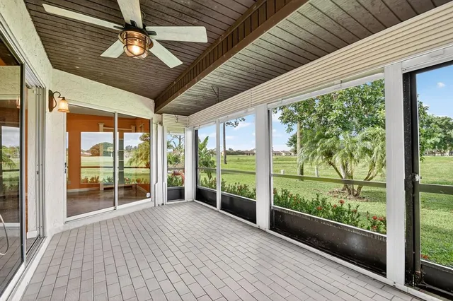 a living room with furniture and view of kitchen