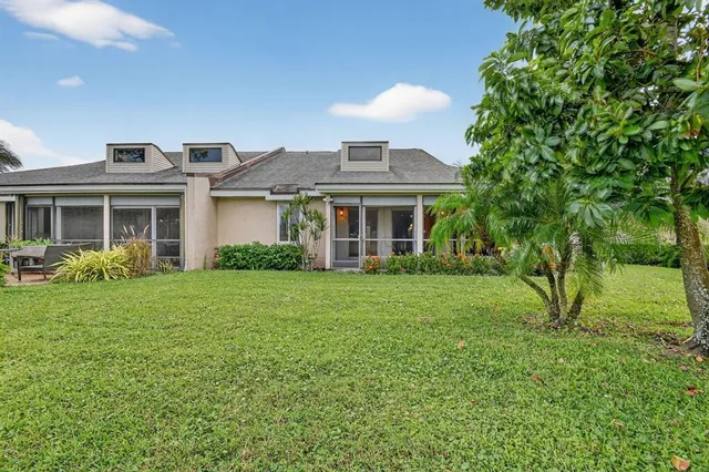 an aerial view of a city with lots of residential buildings and mountain view in back
