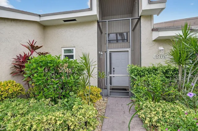a view of a hallway with a sink and a refrigerator