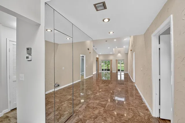 a kitchen with stainless steel appliances granite countertop a sink a stove and microwave with wooden floor