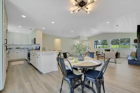 a view of a dining room with furniture and wooden floor
