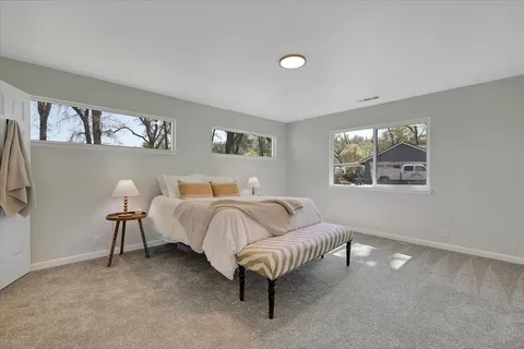 a spacious bedroom with a bed and a couch