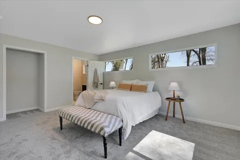 a bedroom with a bed and a lamp