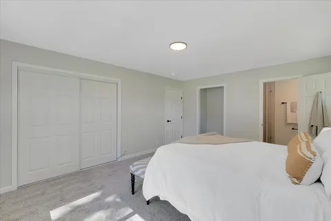a bedroom with a bed and a closet