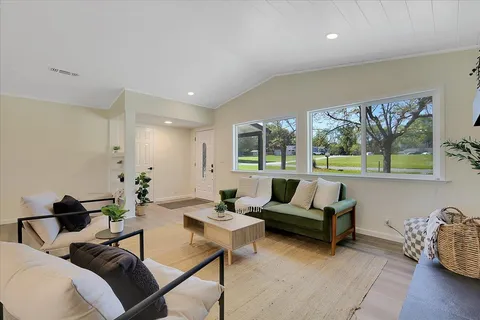a living room with furniture and a large window