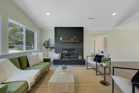 a living room with furniture and a fireplace