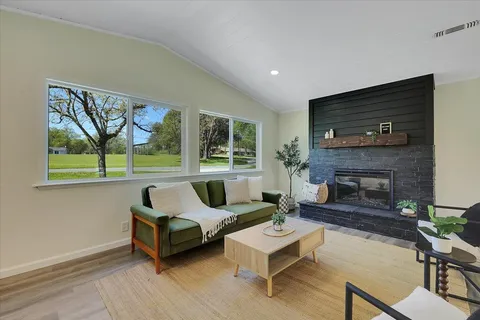 a living room with furniture and a fireplace