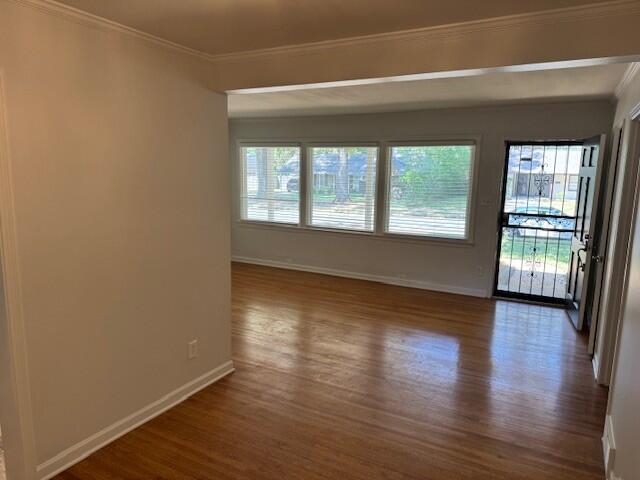 4803 Hummingbird Lane Memphis, TN 38117 - Photo 8 of 36 an empty room with wooden floor and windows