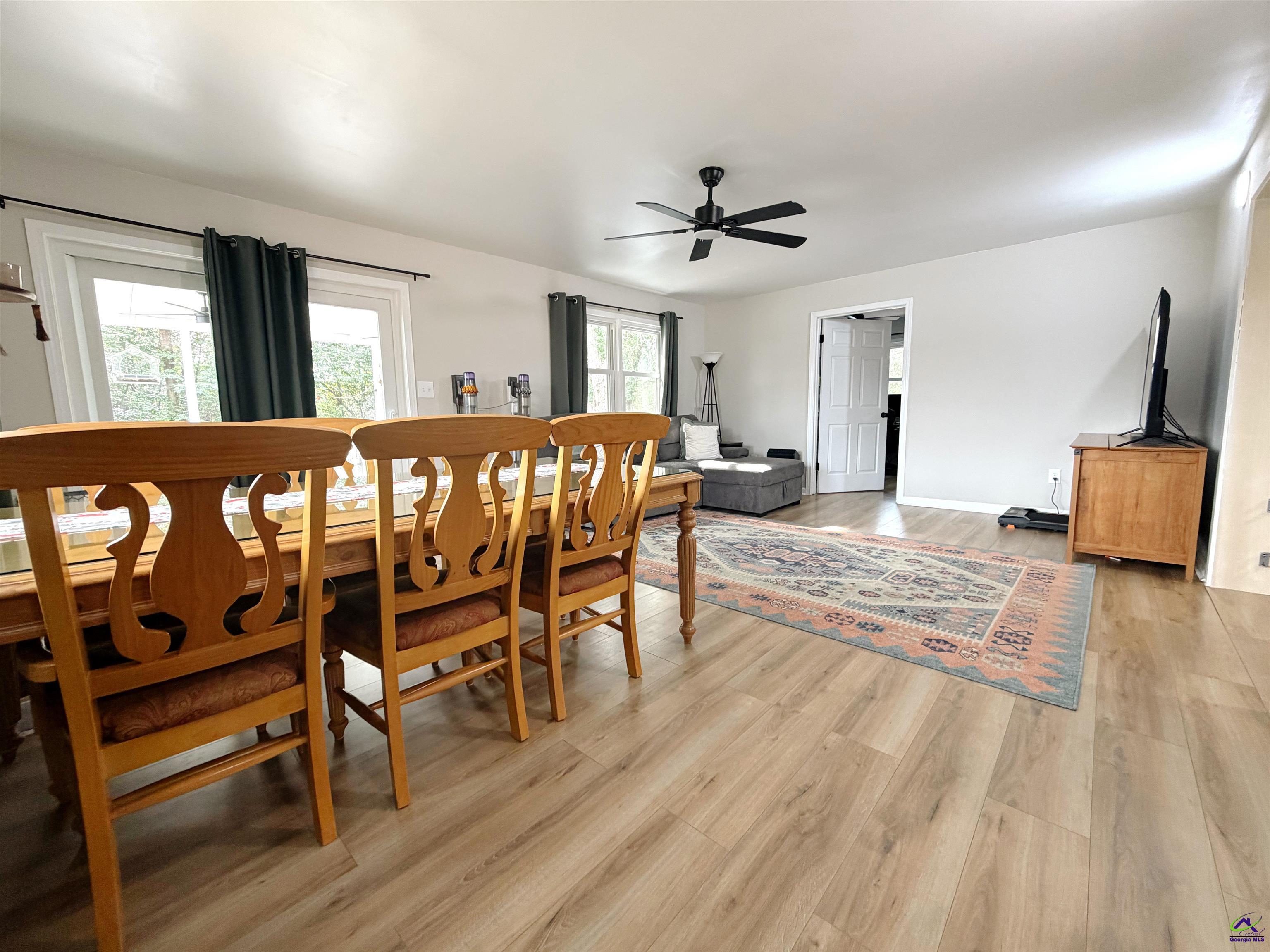 108 Weaver Road Warner Robins, GA 31093 - Photo 8 of 26 a large living room with a dining table chairs with wooden floor