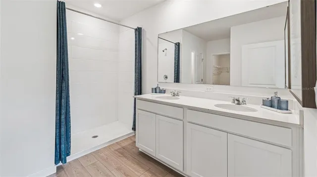 a bathroom with 2 sink and a mirror