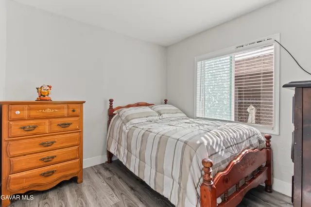 a living room with a bed window and a flat screen tv