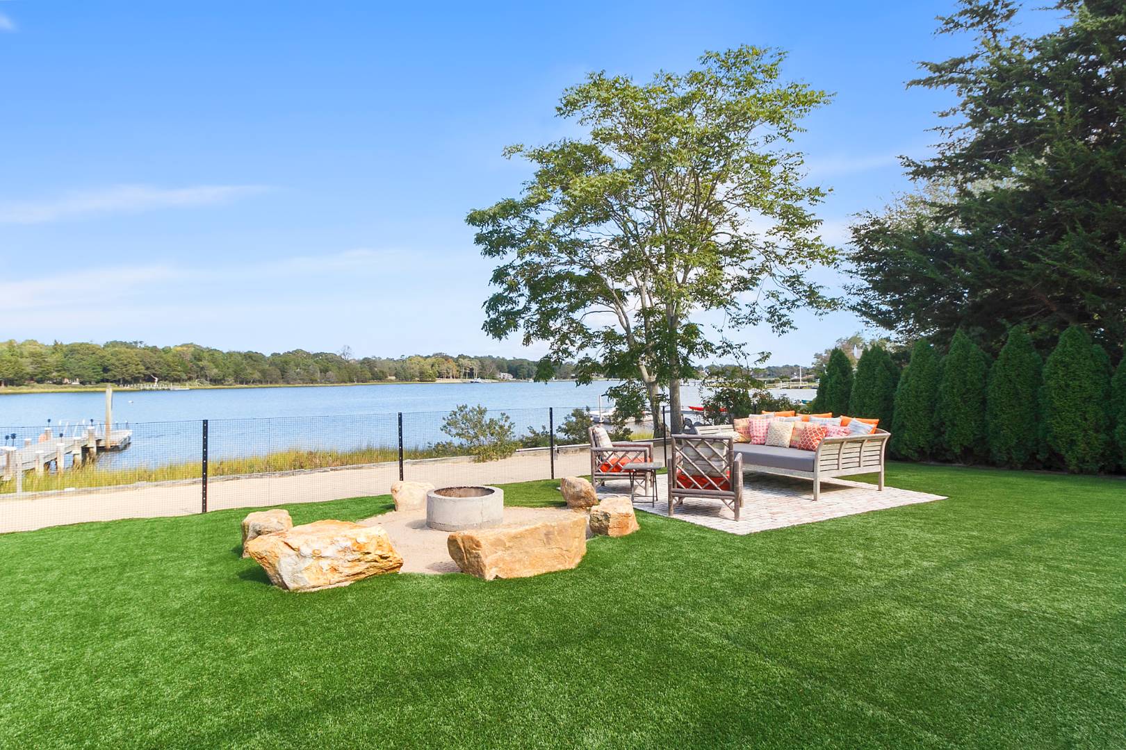43 Harbor Drive Sag Harbor, NY 11963 - Photo 12 of 29 a view of a lake with lawn chairs and a big yard
