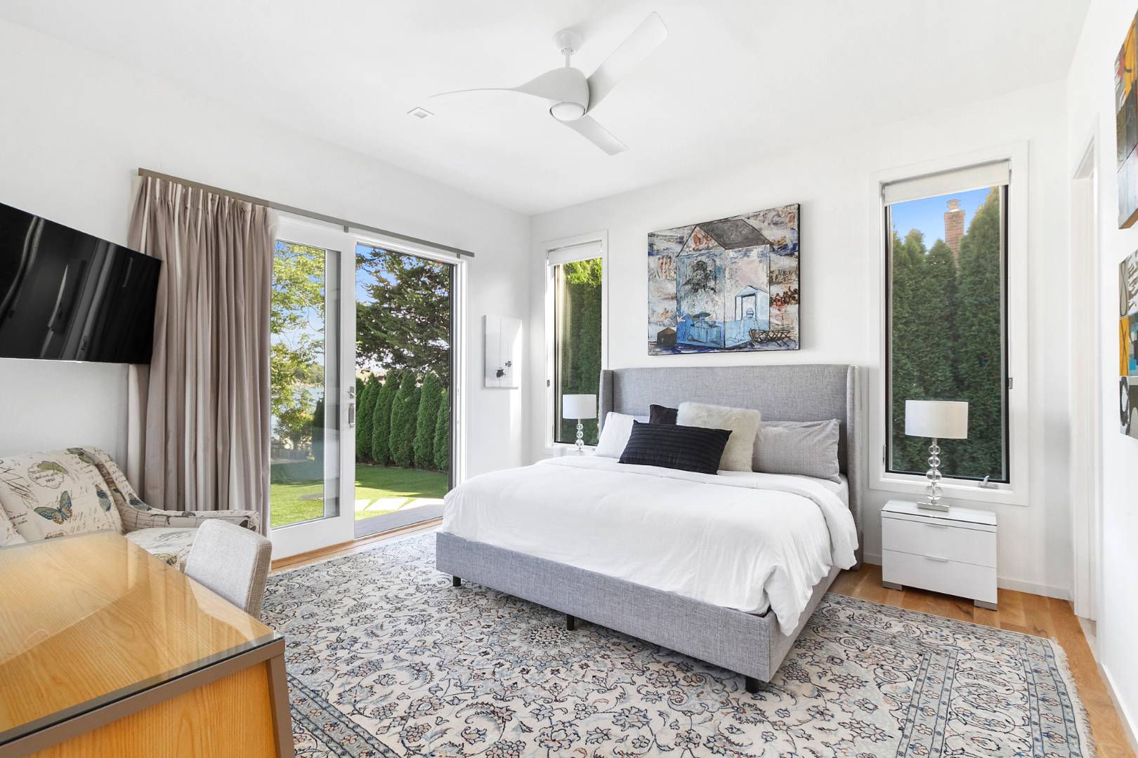 43 Harbor Drive Sag Harbor, NY 11963 - Photo 20 of 29 a bedroom with a bed and glass door