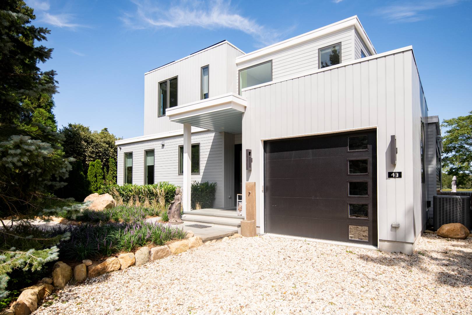 43 Harbor Drive Sag Harbor, NY 11963 - Photo 3 of 29 a front view of a house with a yard and garage