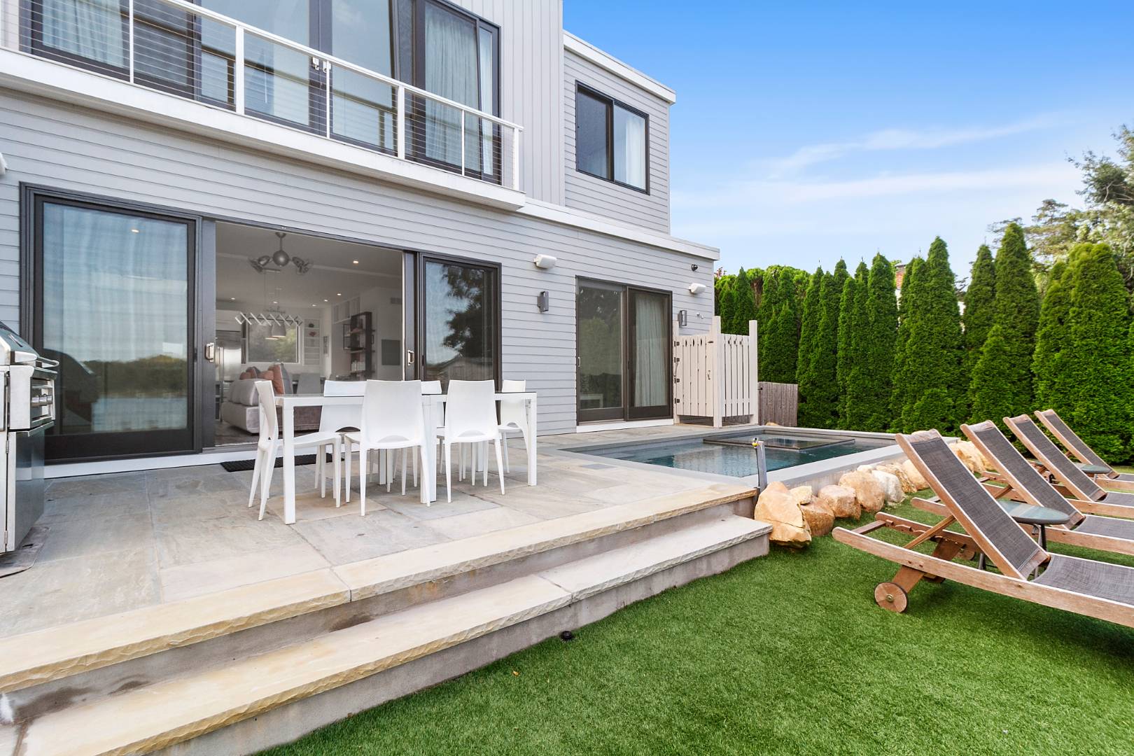 43 Harbor Drive Sag Harbor, NY 11963 - Photo 7 of 29 a view of a patio with table and chairs with plants and wooden fence
