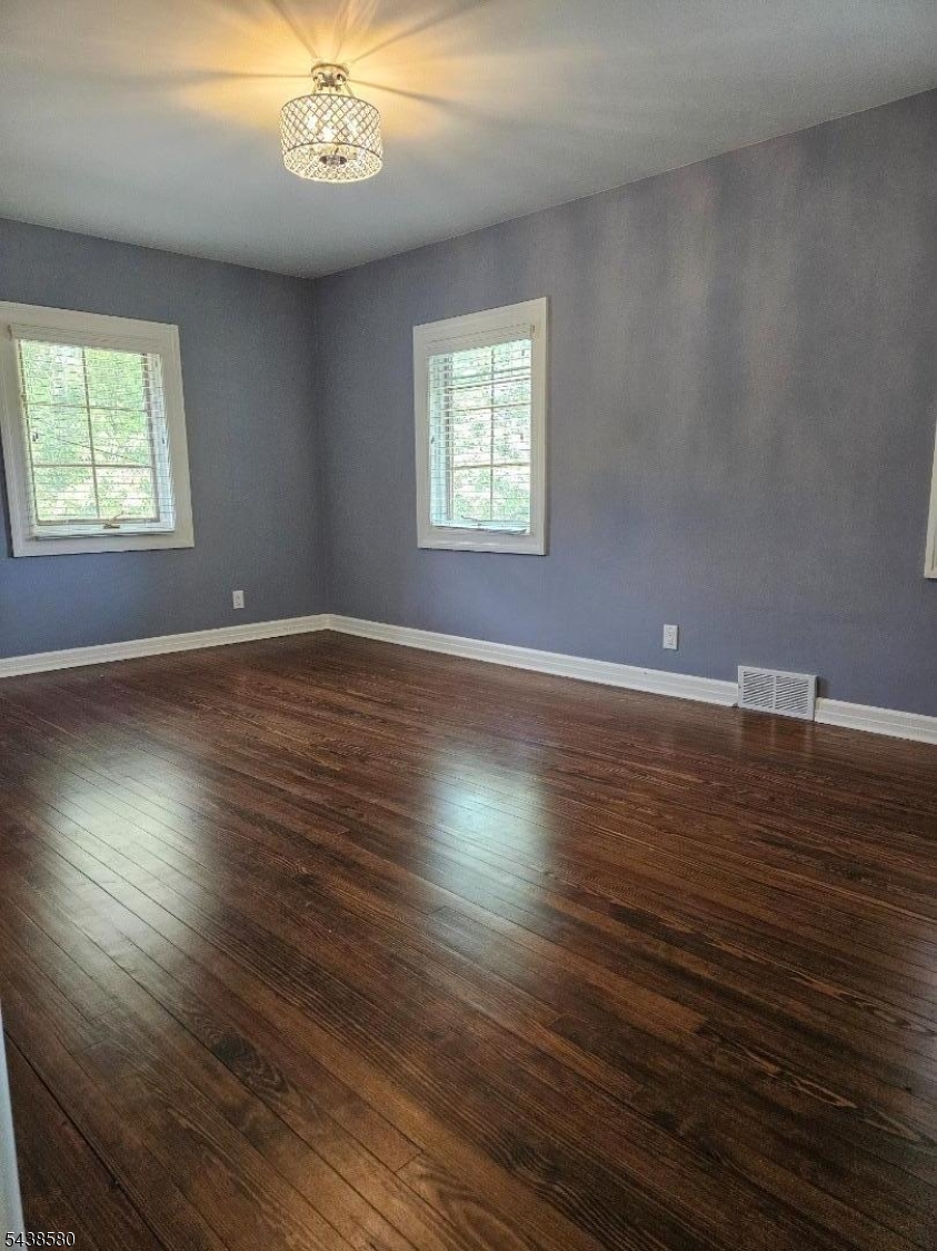 218 Devon Road Essex Fells, NJ 07021 - Photo 15 of 24 an empty room with wooden floor and windows