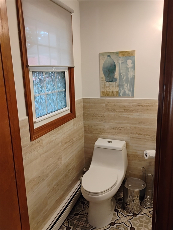 9 Packard Road Milford, MA 01757 - Photo 13 of 30 a white toilet sitting next to a small bathroom