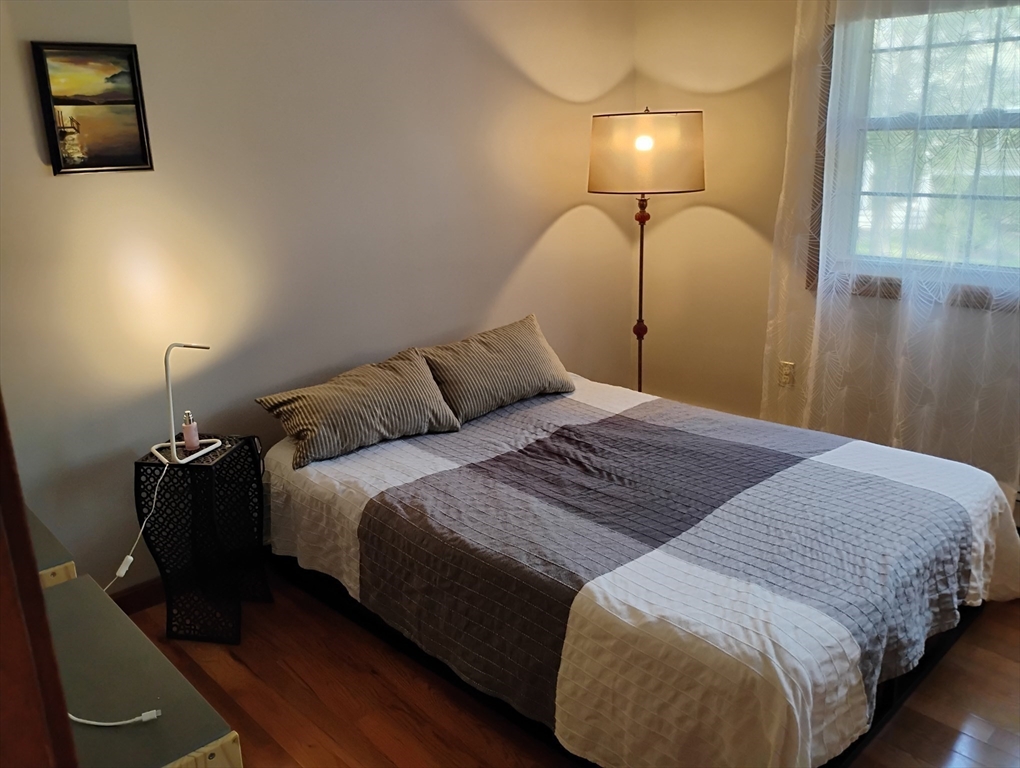 9 Packard Road Milford, MA 01757 - Photo 20 of 30 a bedroom with a bed and wooden floor