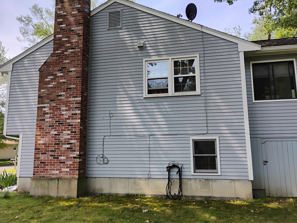 9 Packard Road Milford, MA 01757 - Photo 2 of 30 a front view of a house with a yard