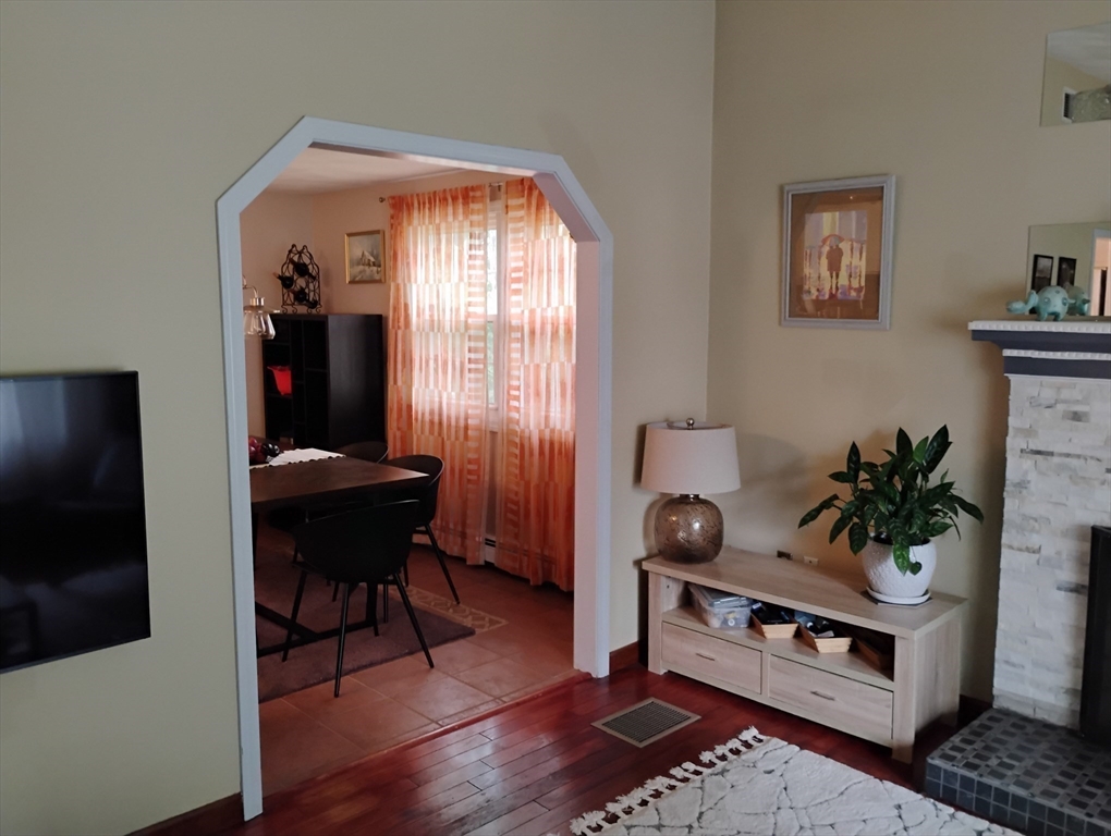 9 Packard Road Milford, MA 01757 - Photo 6 of 29 a living room with furniture a dining table and a potted plant